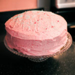 pink layer cake on a cake stand