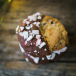 closeup of chocolate chip cookie dipped in chocolate and peppermint