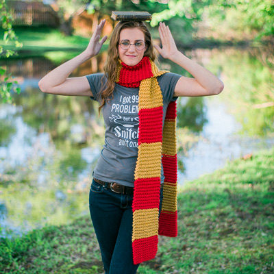 teenager balancing a book on her head and wearing a color block scarf