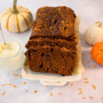 sliced pumpkin bread with cream cheese sauce and pumpkins