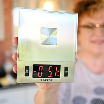 woman holding a food scale