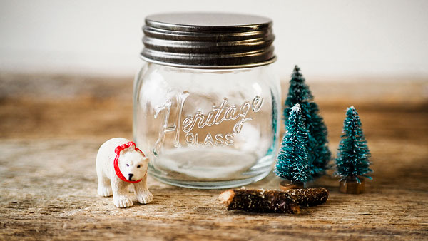 a miniature polar bear with bottle brush trees to be placed in a small mason jar