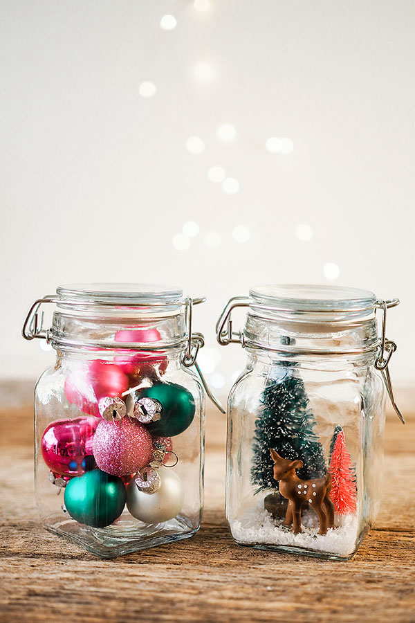 two small decorative jars with Christmas ornaments