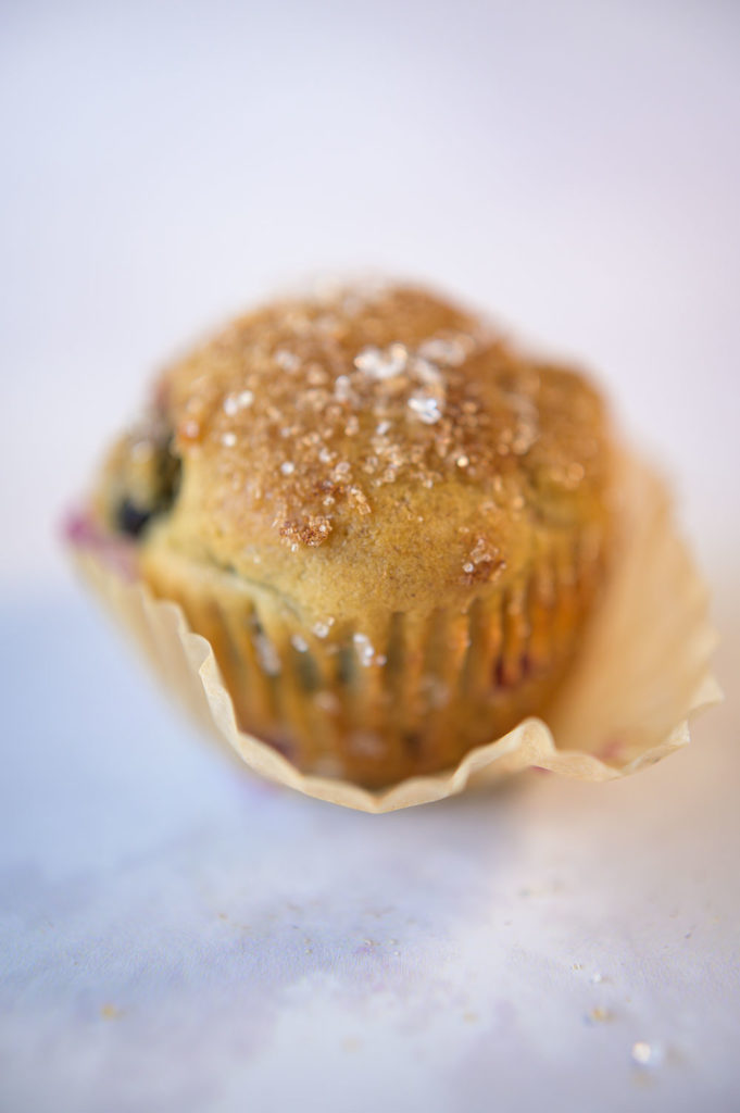 perfectly baked blueberry muffin with wrapper coming off