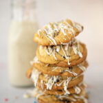 stack of easter cookies with a small bottle of milk