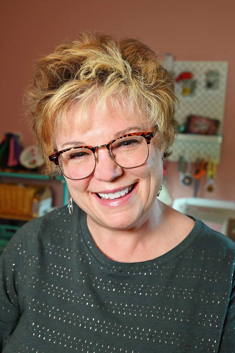 Smiling woman in a sewing room