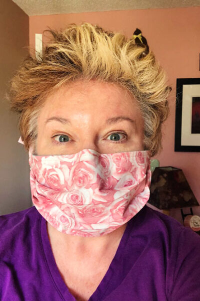 front view of woman in a pink fabric face mask
