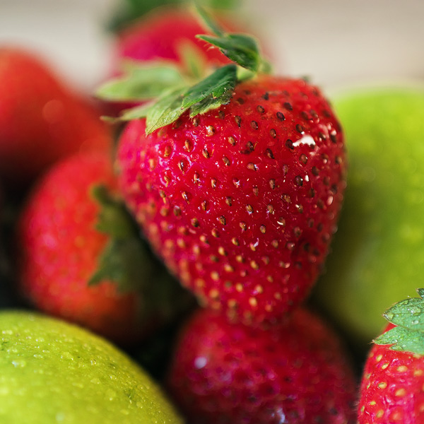 extreme closeup of a ripened strawberry with water droplets