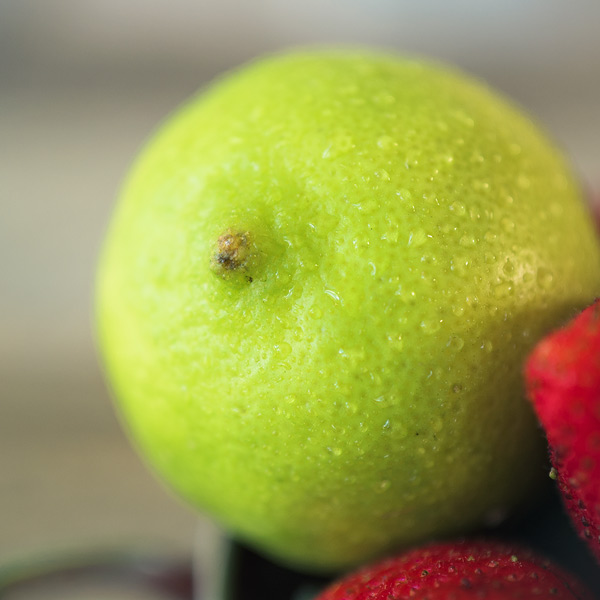 close up view of a lime with water droplets all over