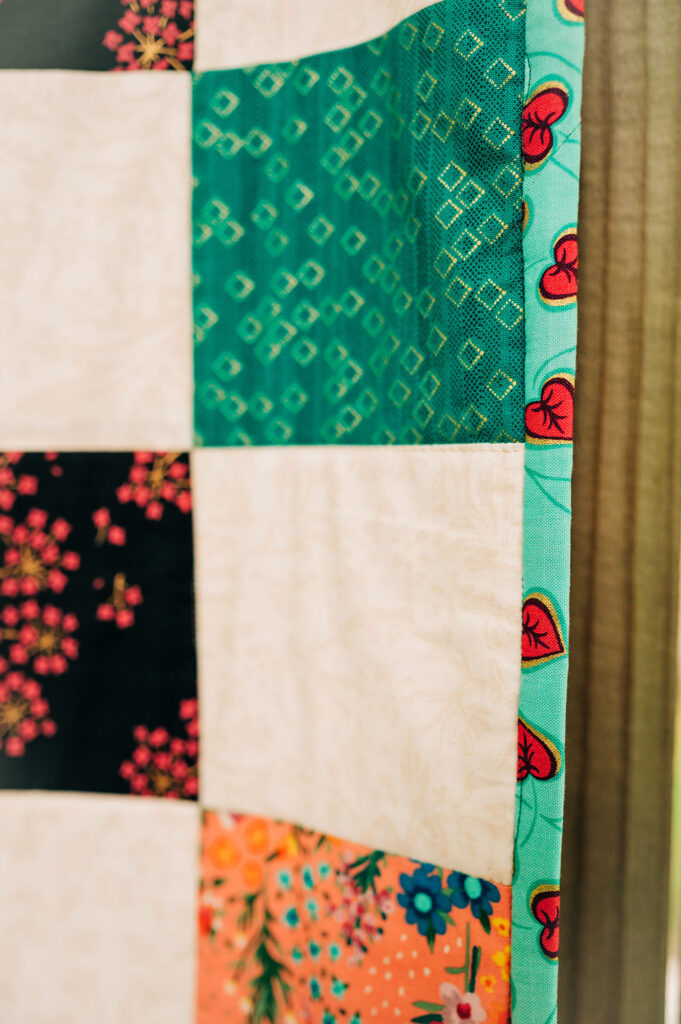 closeup of the quilt binding and patchwork quilt blocks.
