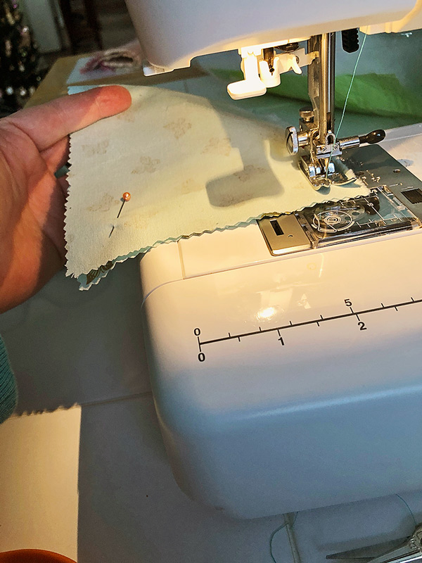 small piece of fabrics being sewn on a sewing machine