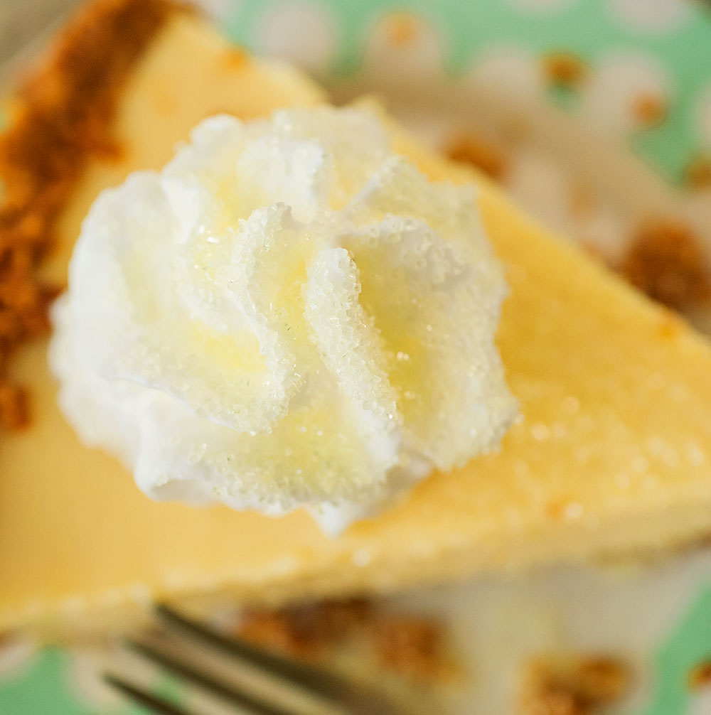 overhead view of the sugar sprinkled whipped cream on top a lemon pie