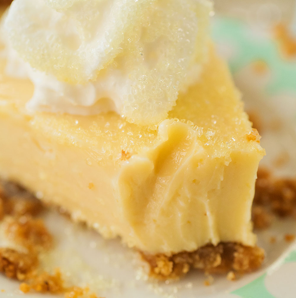 super close up view of lemon pie with a bit taken out