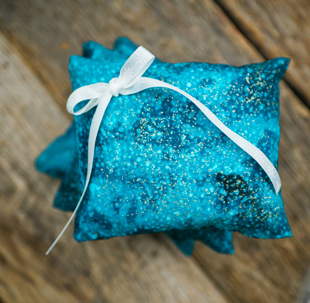 closeup view of a bright blue pillow with a white bow.