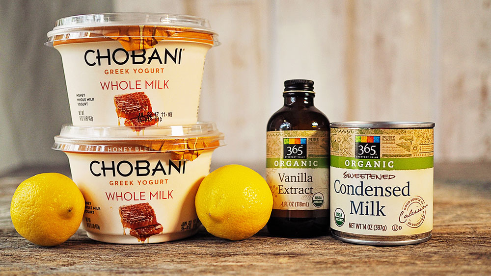 The ingredients for lemon frozen yogurt. Chobani honey flavored greek whole milk yogurt, vanilla, sweetened condensed milk and fresh lemons.