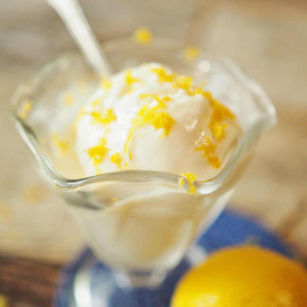 closeup view of lemon frozen yogurt topped with fresh lemon zest.
