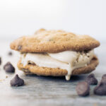 closeup of vanilla ice cream melting in cookie sandwiches