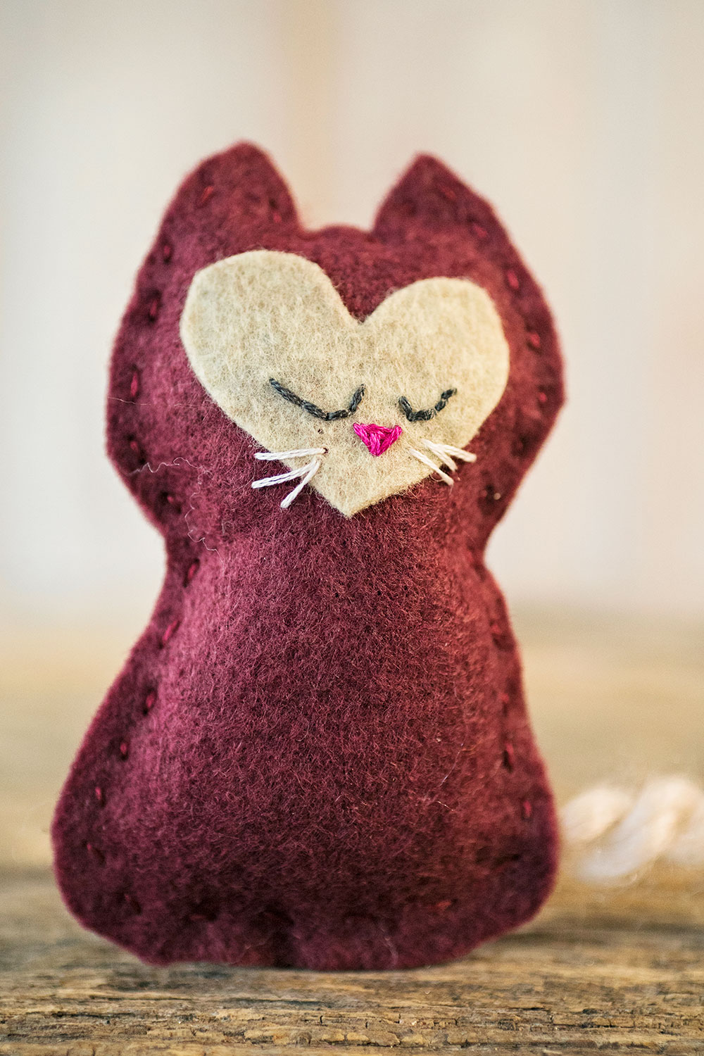 close up of hand sewn felt kitten toy