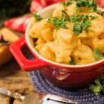 creamy macaroni and cheese topped with fresh minced parsley