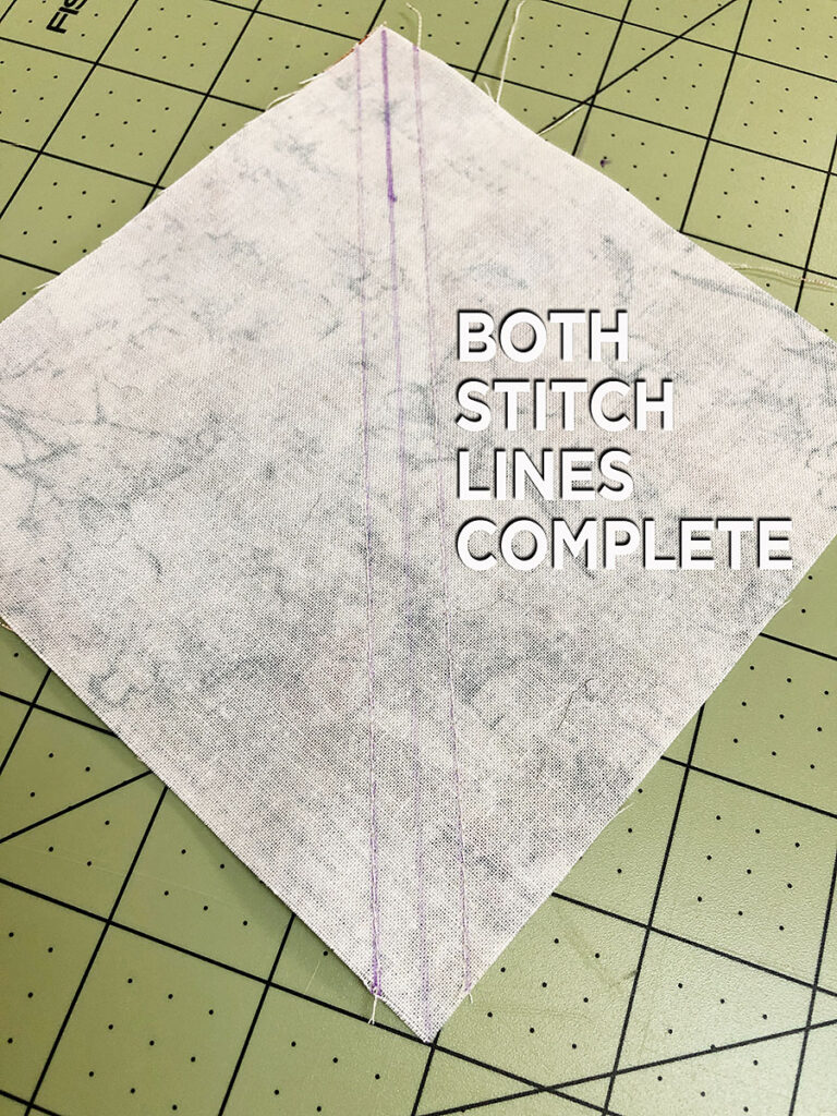 a half square triangle with two stitch lines before cutting