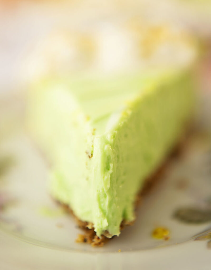 close up view of a slice of no bake key lime cheesecake pie
