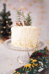 beautiful white cake with miniature deer decorations
