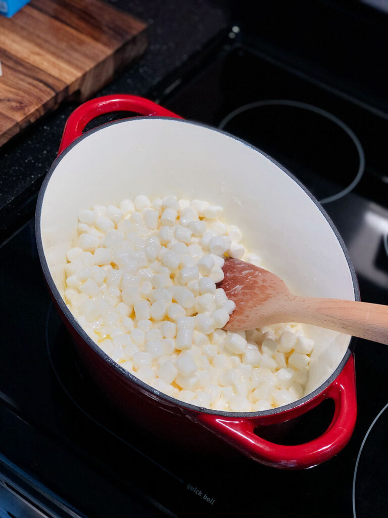 A large sauce pan that's melting butter and marshmallows