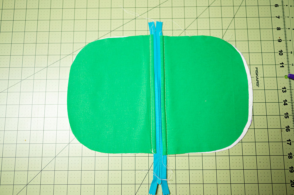 Overhead view of partially sewn quilter zipper pouch showing the top stitch line from the lining side of the project