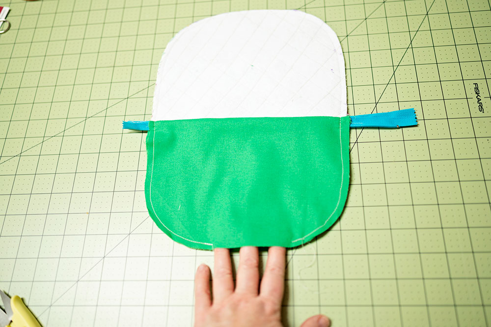 Sewn quilted zipper pouch shown inside out with opening in lining to turn the project right side out