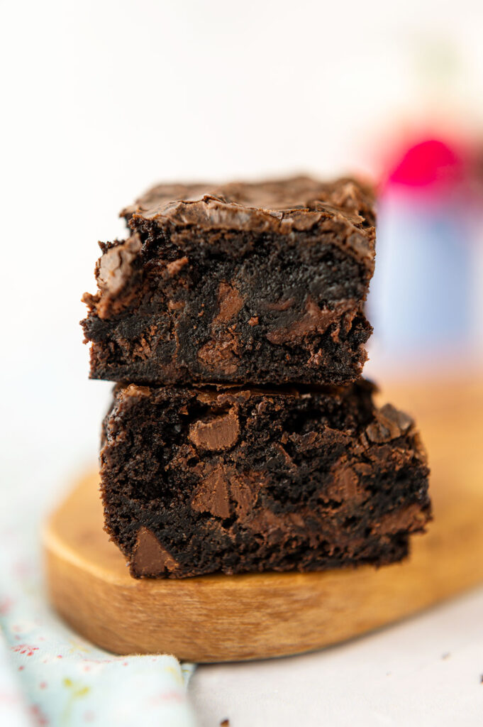 a closeup of a tall stack of thick, chocolate brownies