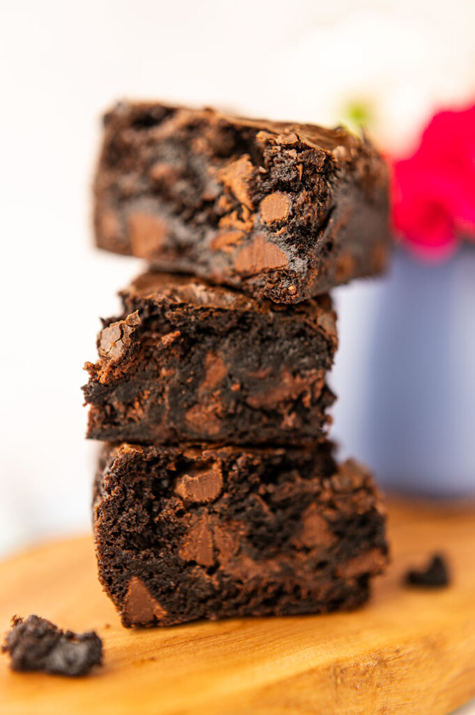 a closeup of a tall stack of thick, chocolate brownies