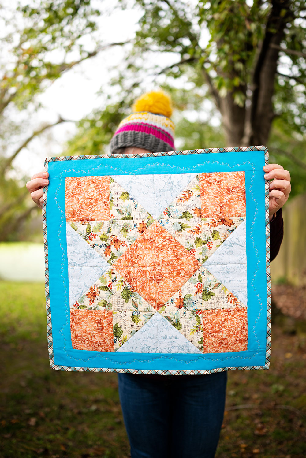 a mini quilt sewn in the ribbon star block pattern