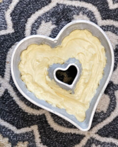 cake batter as seen over head in a heart shaped pan and ready for baking