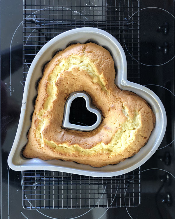 overhead view of a freshly baked cake in a heart shaped pan