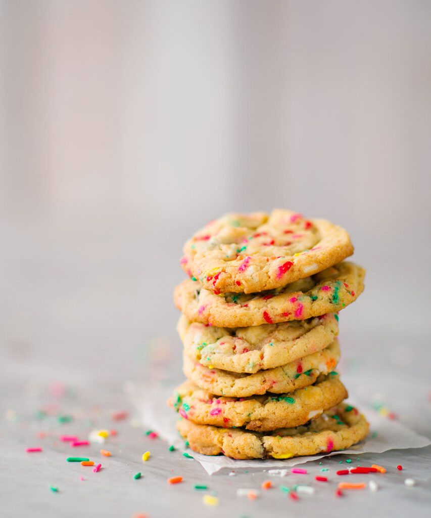 Tall cookie stack with lots of colorful rainbow sprinkles