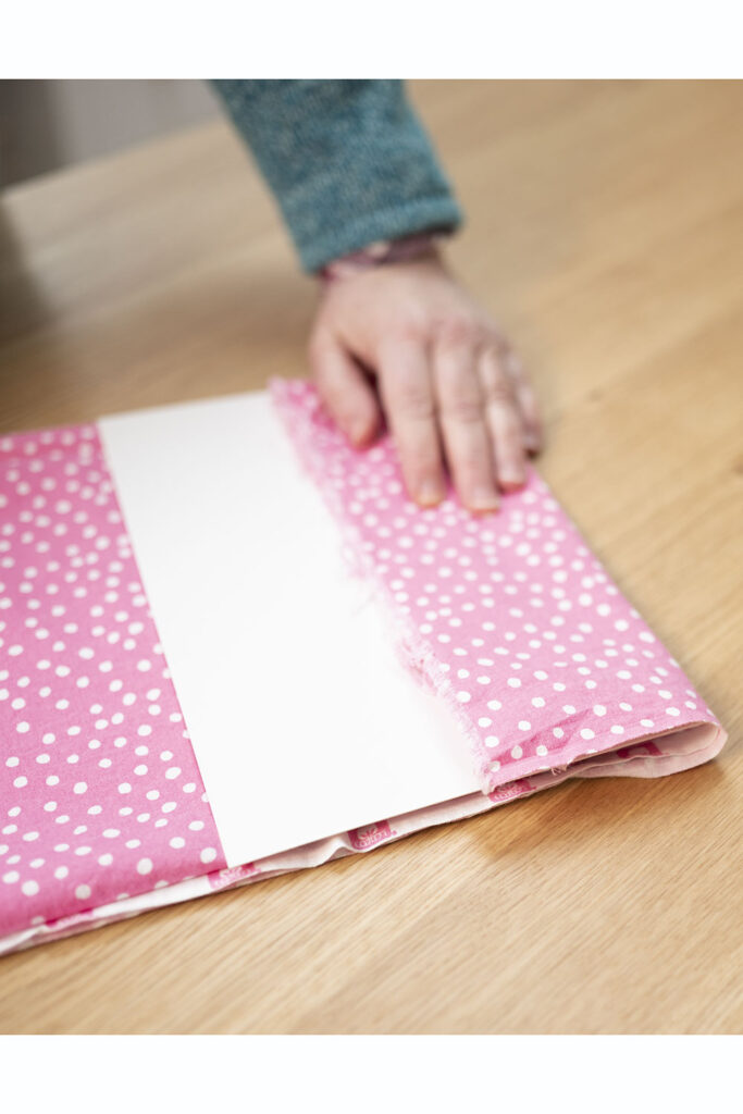 showing placement of a comic book board to aid in folding fabric