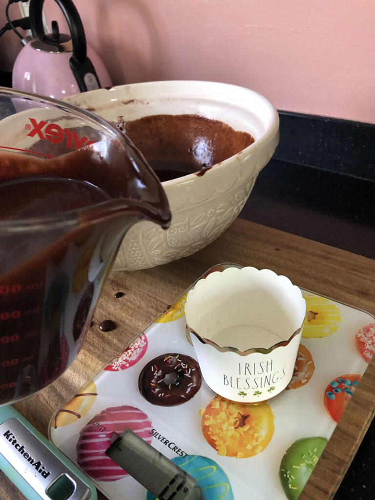 a glass container used to pour the cake batter into the baking cups