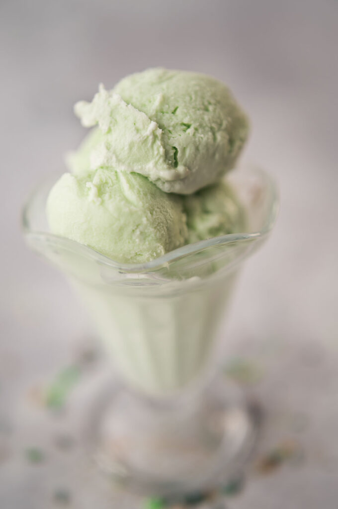 scoops of pale green mint ice cream in a vintage sundae cup