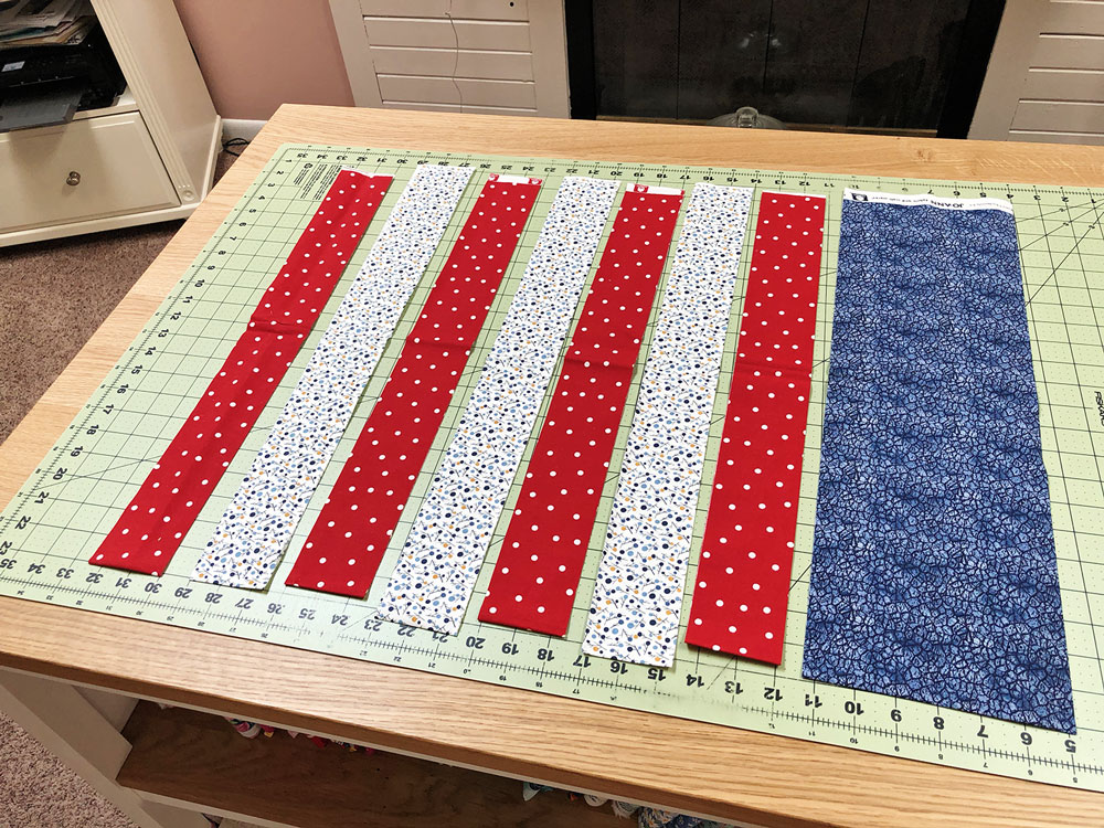strips of red, white, and blue fabric placed for piecing
