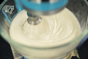 cake batter being mixed in a stand mixer
