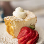 slice of angel food cake served with sliced strawberries and whipped cream