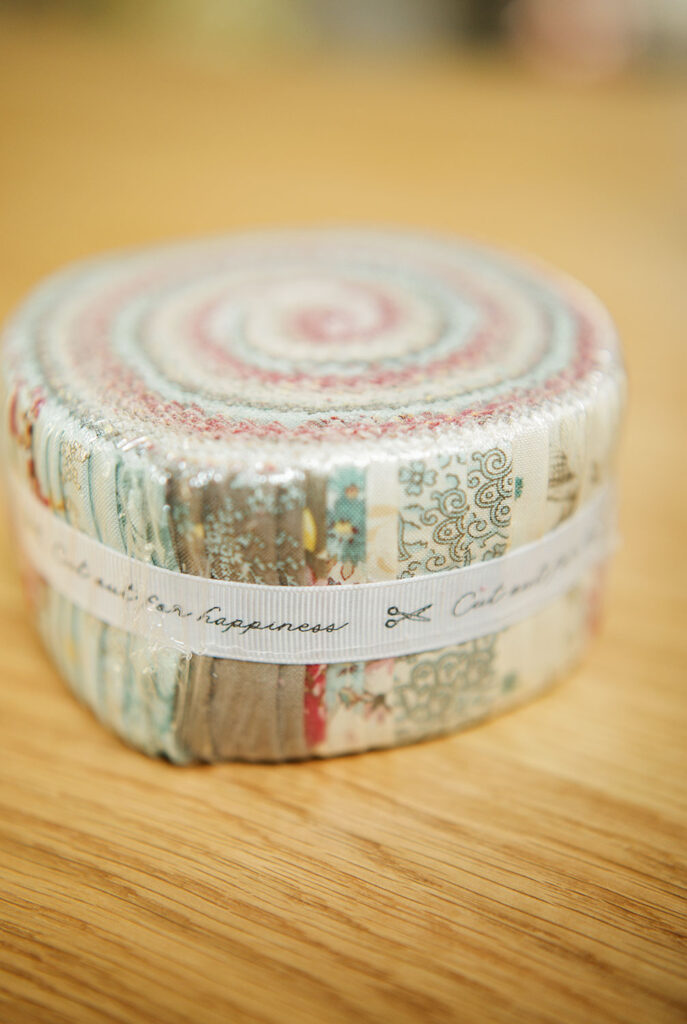 a jelly roll fabric package in pastle colors