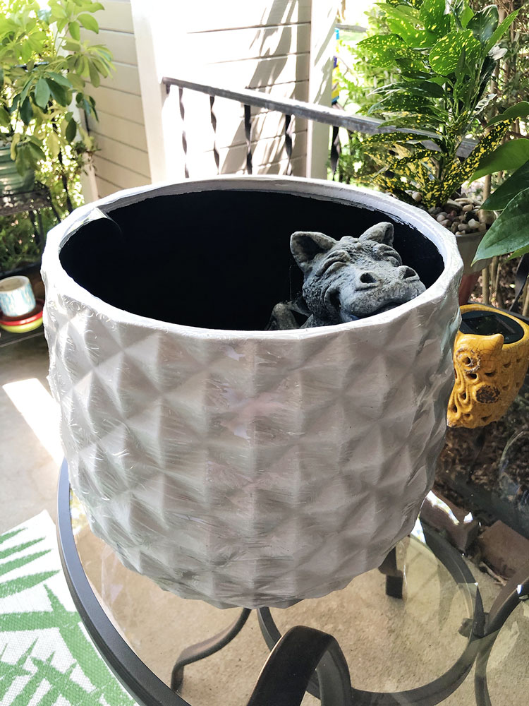 a white planter for a large houseplant