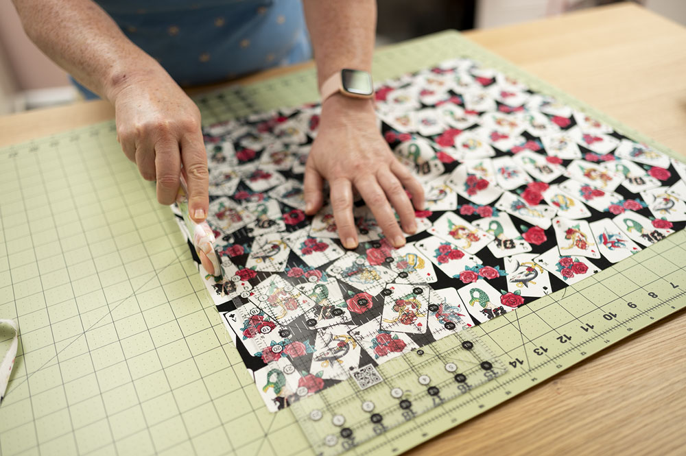 trimming fabric on a cutting mat with a rotary cutter