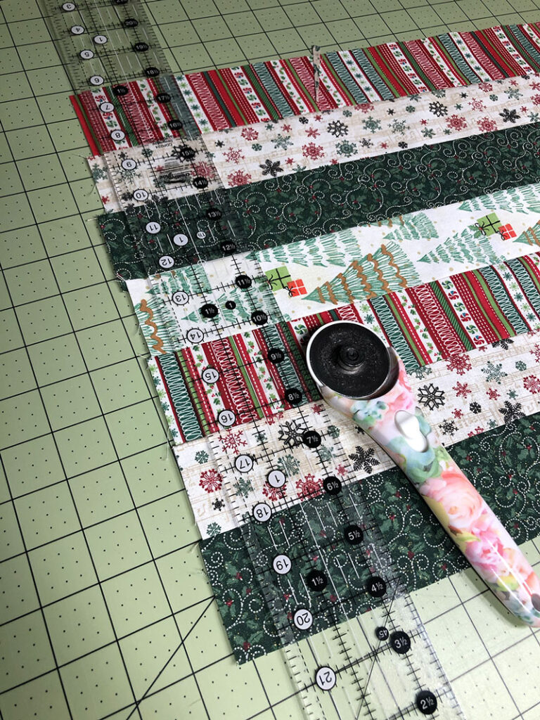 a strip set with a quilting ruler and rotary cutter