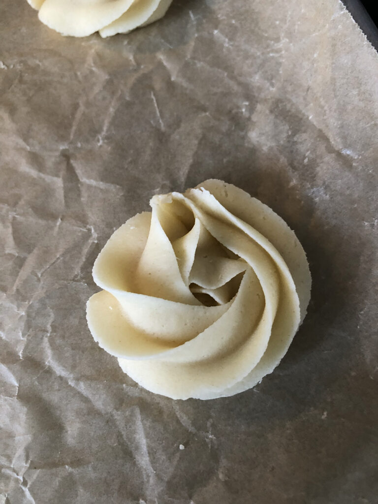piped cookie dough in the shape of a rosette