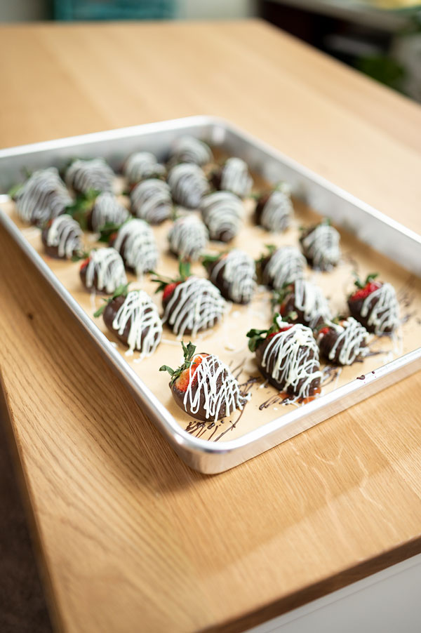 a sheet pan with chocolate dipped strawberries