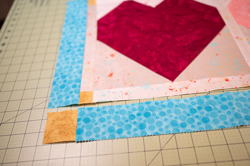 a long piece of border is ready to be sewn onto a table runner