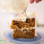 taking a bite of a slice of carrot cake