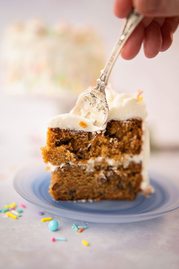 taking a bite of a slice of carrot cake